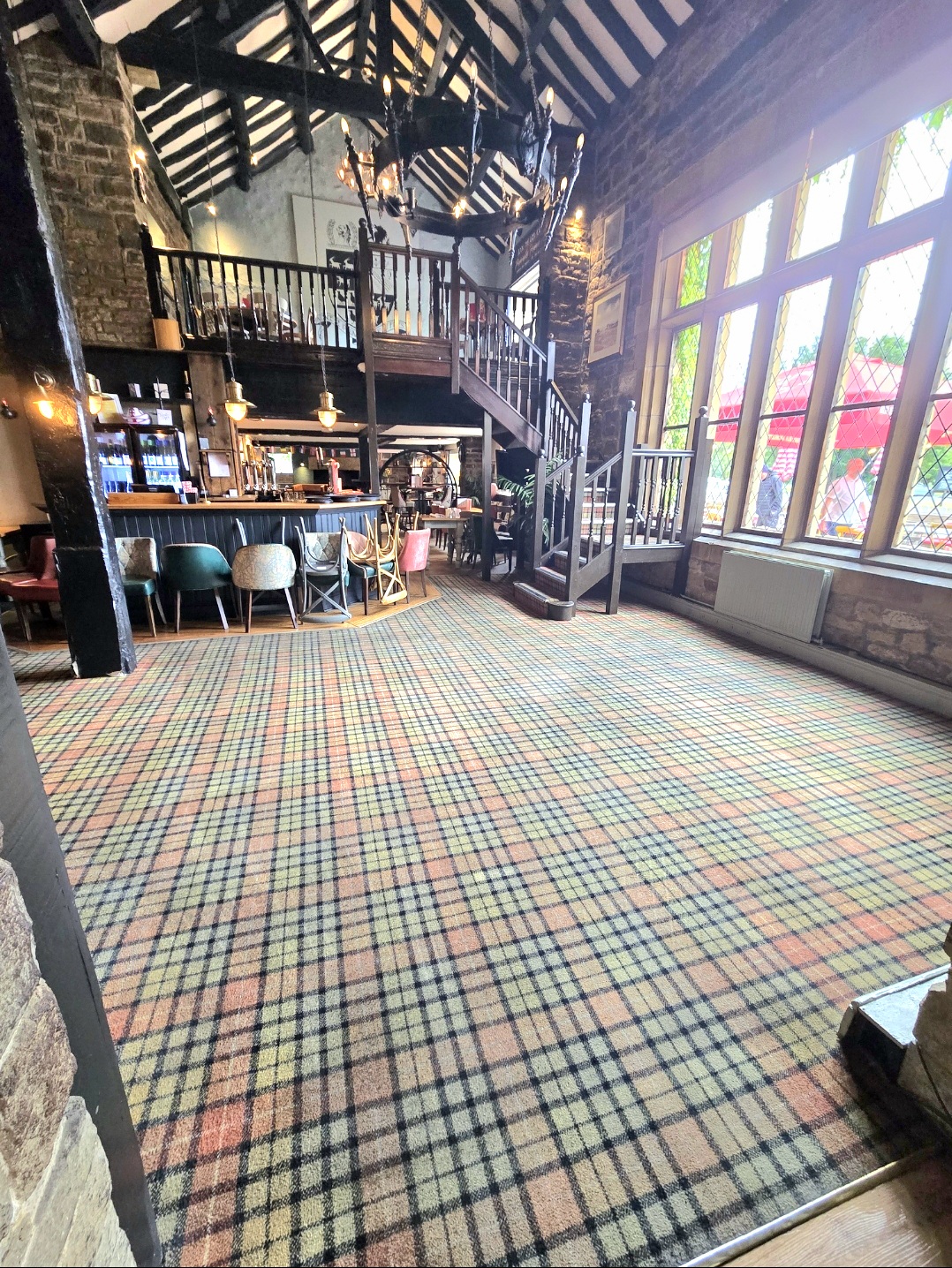 Main bar area at The Stansfield Arms showing cleaned tartan carpet throughout the pub