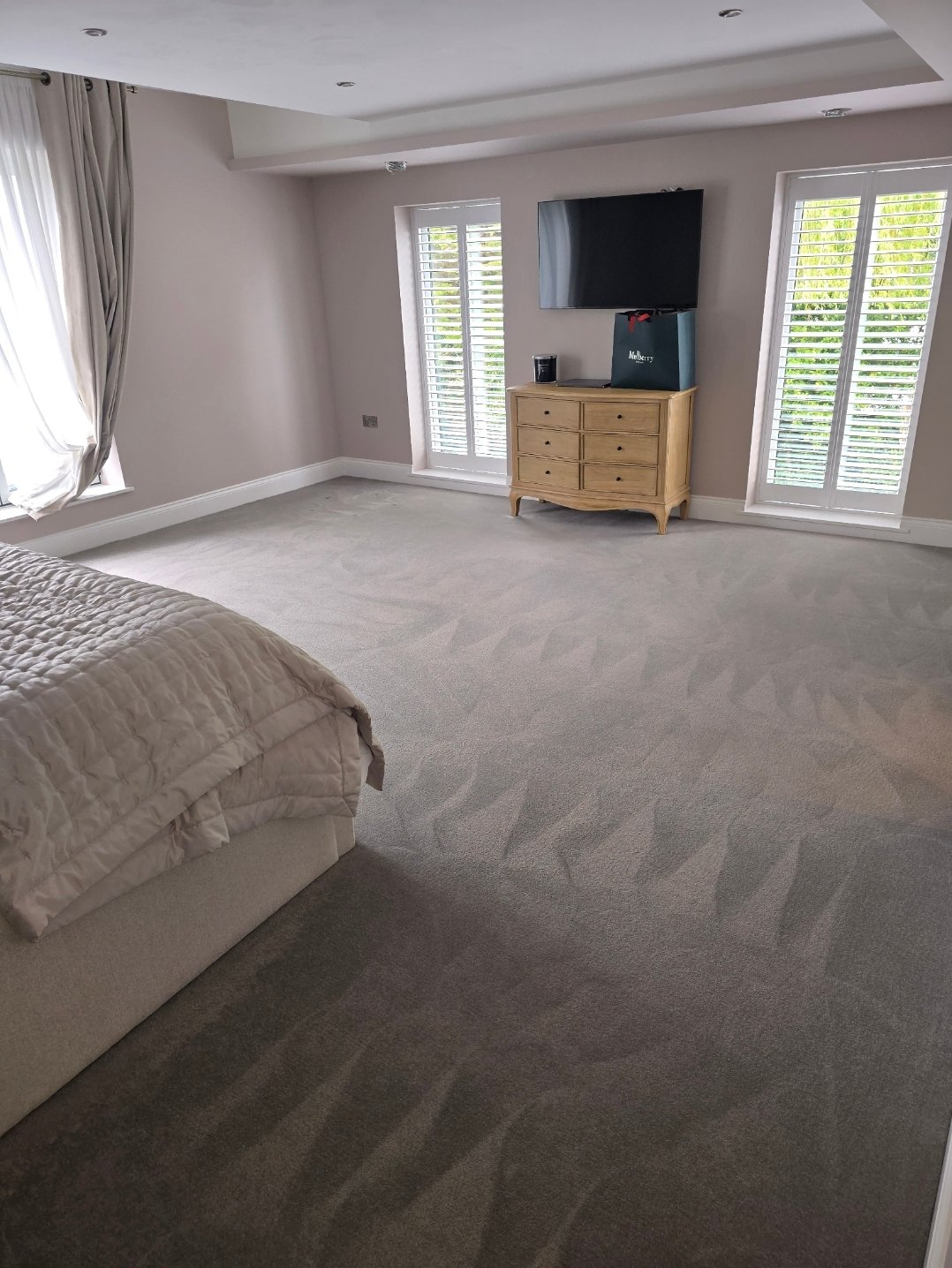 Master bedroom with freshly cleaned light grey carpet in Harrogate