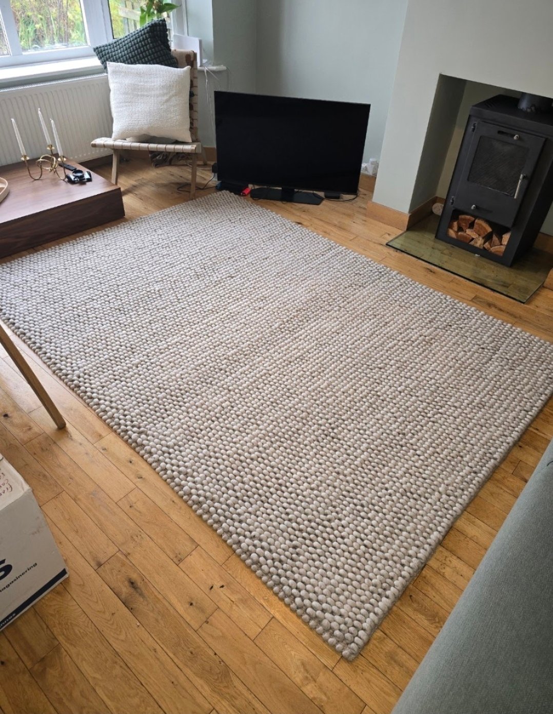 Close-up of a freshly cleaned textured wool rug on wooden flooring in Horsforth
